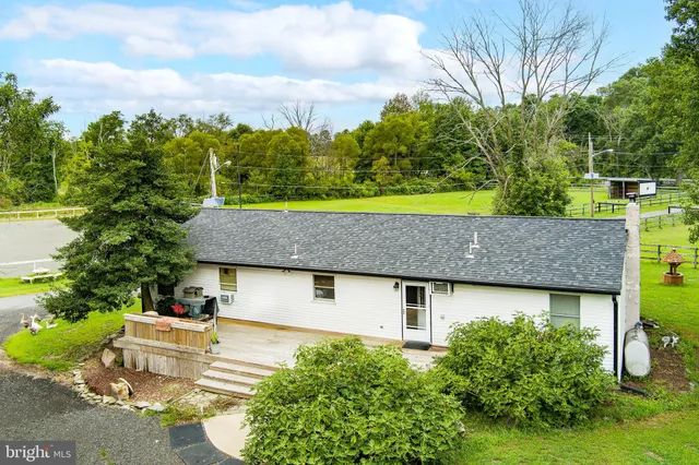 an aerial view of a house with yard swimming pool and outdoor seating