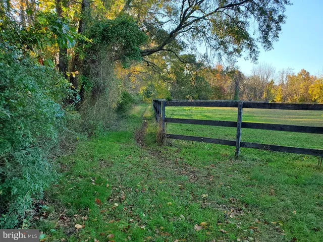 a view of a swimming pool with an outdoor seating and a yard