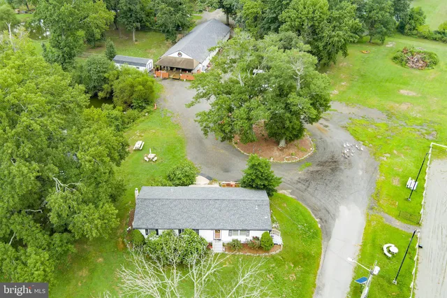 an aerial view of a house with a yard basket ball court and outdoor seating