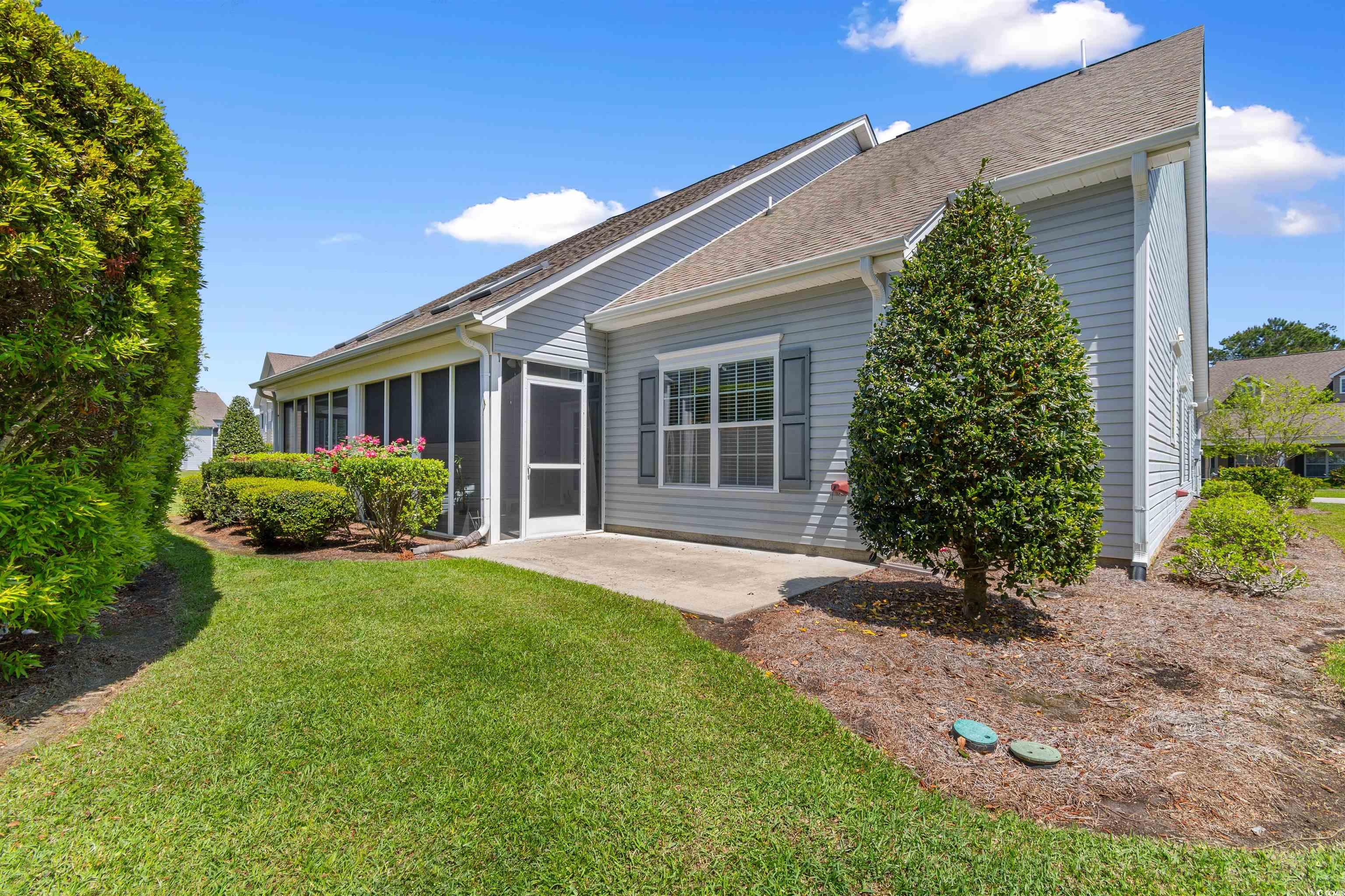 1000 Red Sky Lane, Unit 101 Murrells Inlet, SC 29576 - Photo 26 of 40 Rear view of house featuring a patio, a shingled r