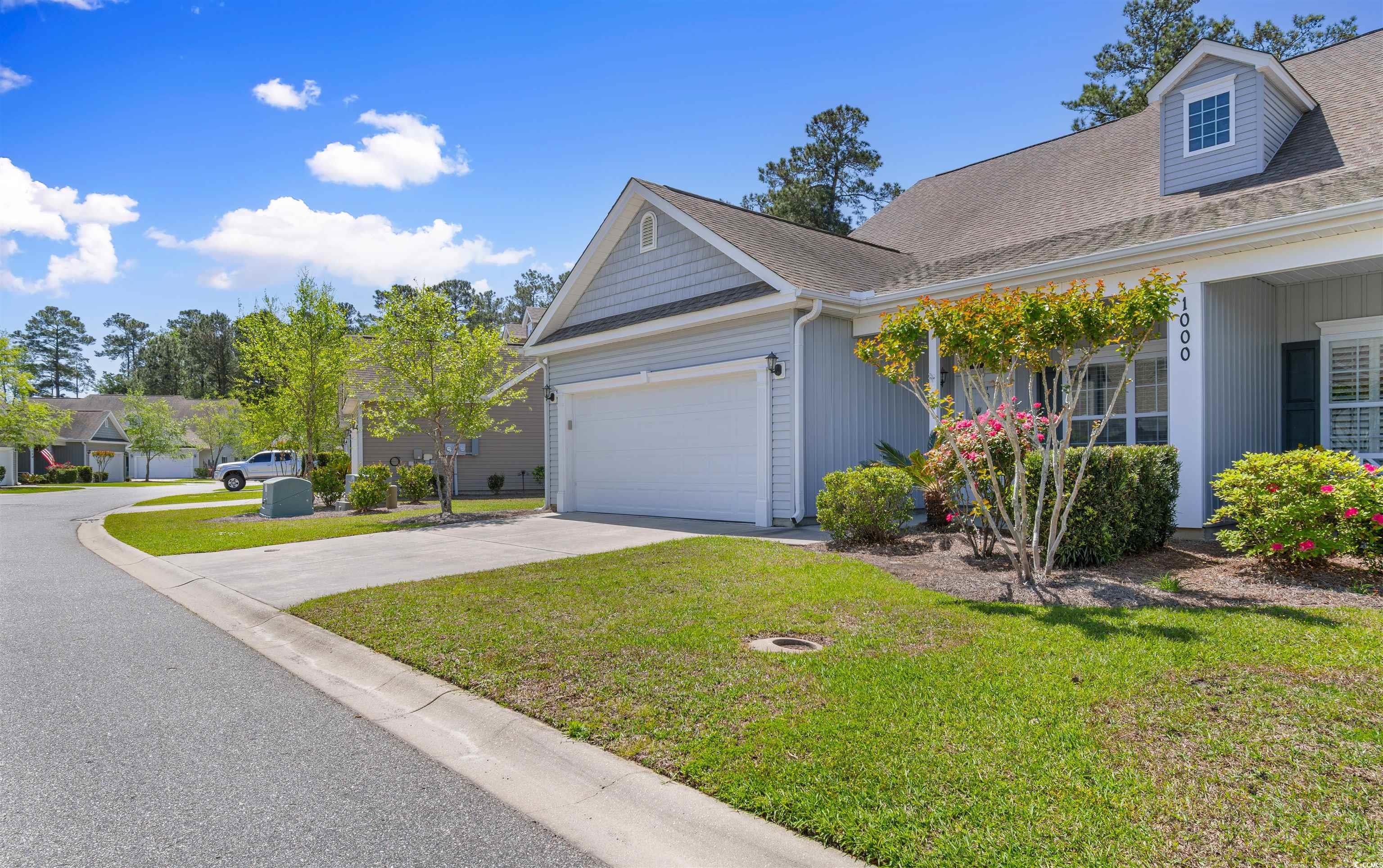 View of side of property with an attached garage,