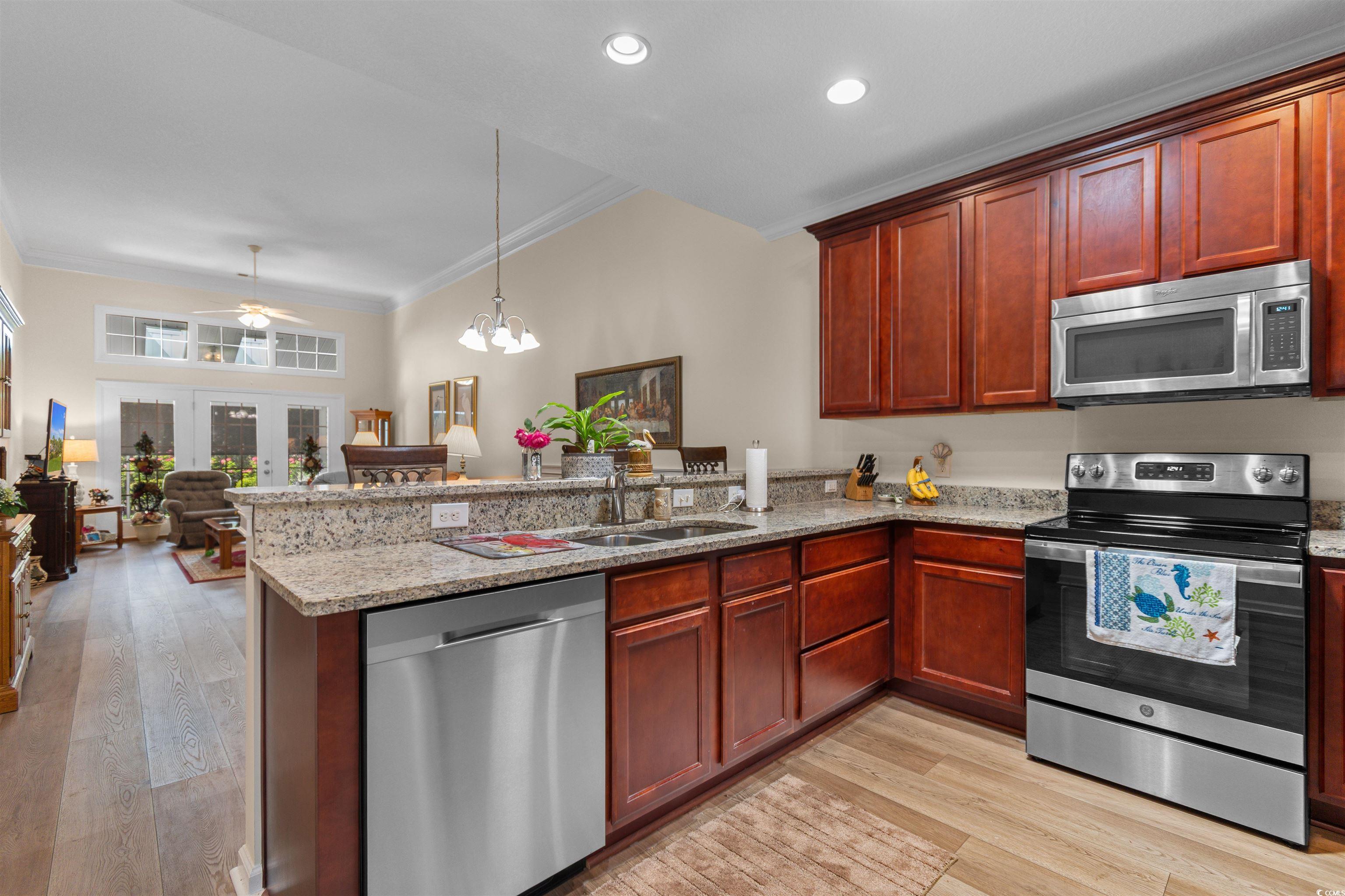 1000 Red Sky Lane, Unit 101 Murrells Inlet, SC 29576 - Photo 39 of 40 Kitchen featuring a sink, open floor plan, a penin