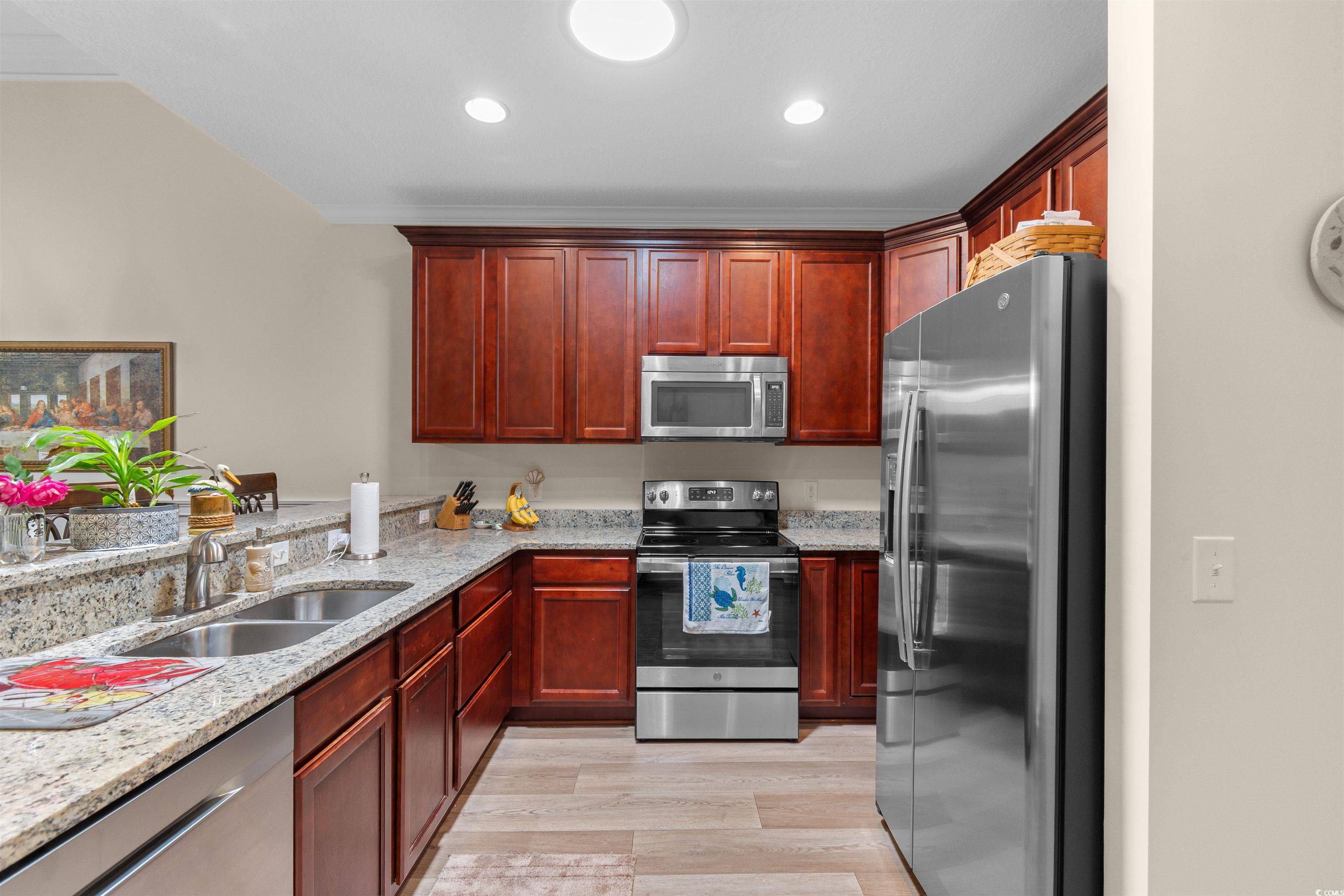 Kitchen featuring a sink, appliances with stainles