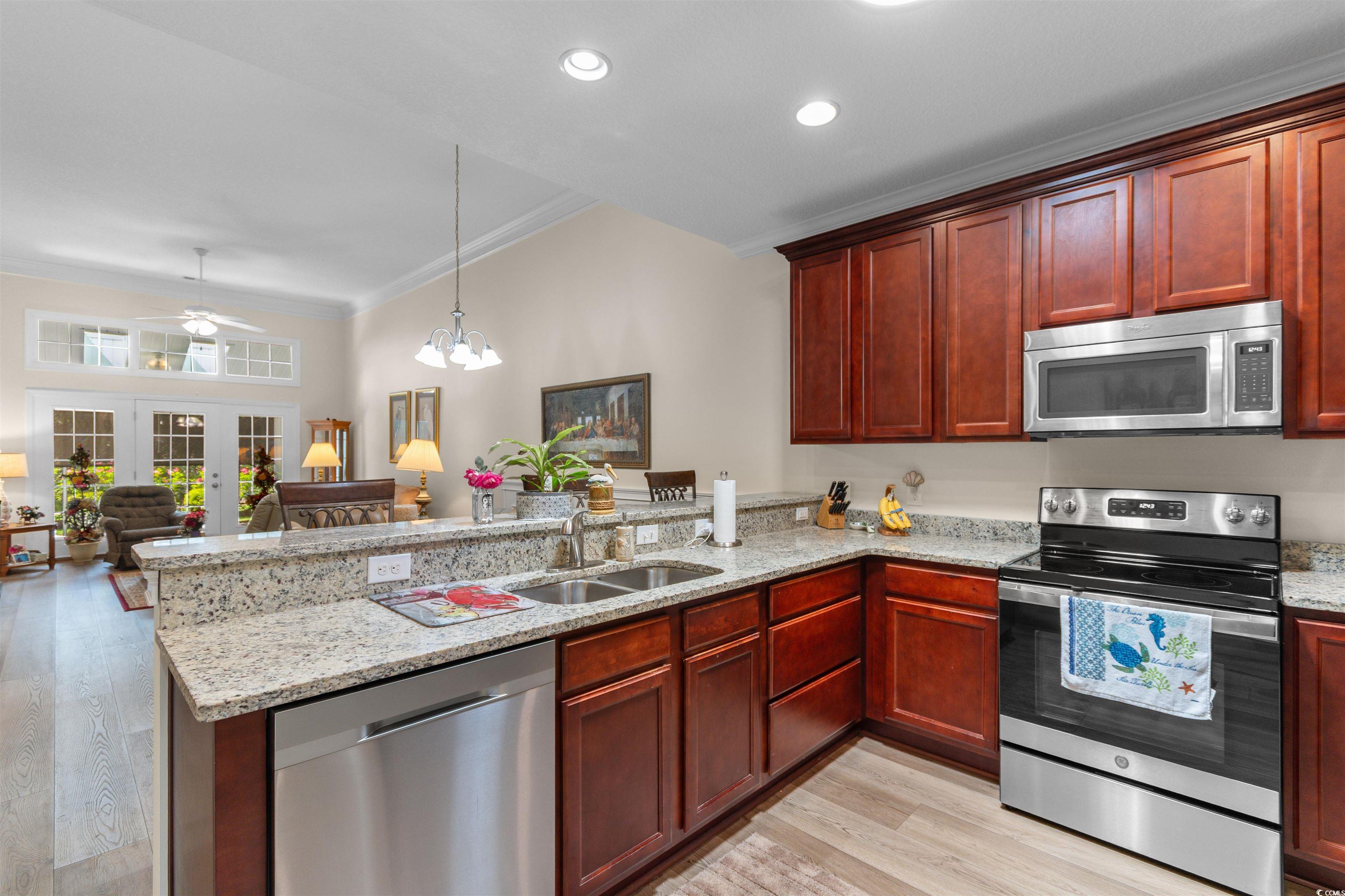 1000 Red Sky Lane, Unit 101 Murrells Inlet, SC 29576 - Photo 40 of 40 Kitchen with open floor plan, a peninsula, dark br