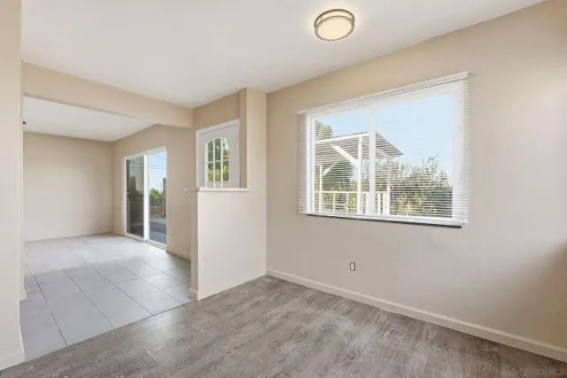 an empty room with windows and closet