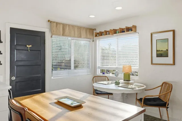a bedroom with a table and chairs