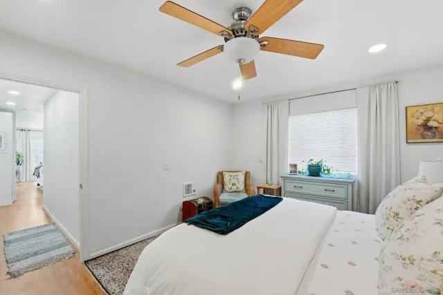 a bedroom with a bed a window and couch