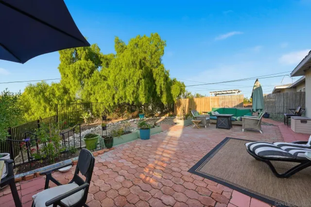 a view of a backyard with sitting area