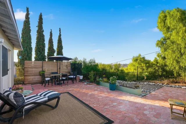a view of a house with backyard sitting area