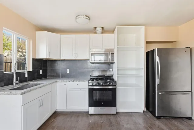 a kitchen with cabinets and stainless steel appliances