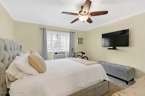 a bedroom with a large bed and a flat screen tv