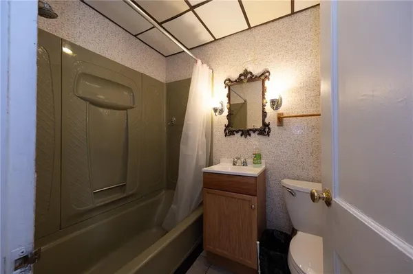 a bathroom with a toilet sink and mirror