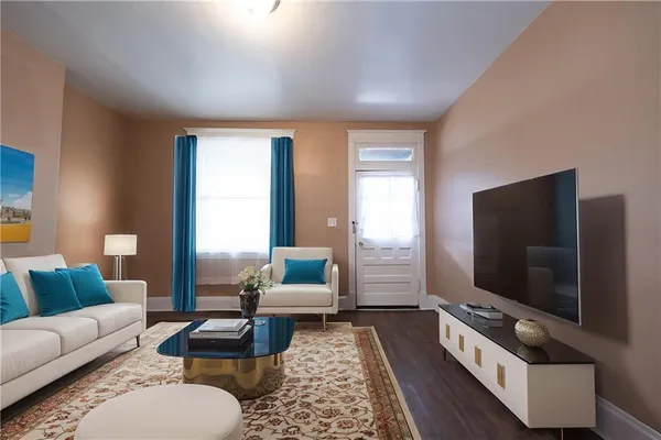 a living room with furniture and a flat screen tv