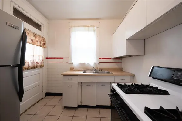 a kitchen with stainless steel appliances a stove a sink and a refrigerator