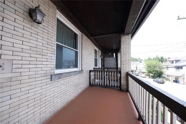 a view of a balcony with wooden floor