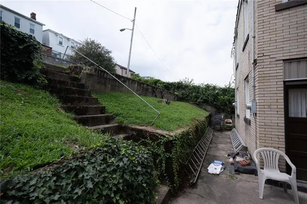 a view of a chair and table in backyard