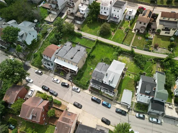 an aerial view of multiple houses with yard