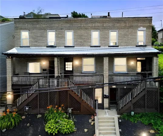 a view of a house with iron fence