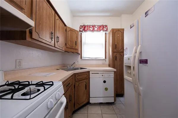 a kitchen with stainless steel appliances granite countertop a stove and a refrigerator
