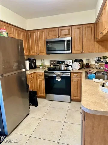 a kitchen with stainless steel appliances granite countertop a stove top oven a refrigerator a sink and dishwasher