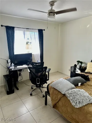 a bedroom with a bed window and dresser