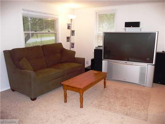 7803 Sutter Road Greensboro, NC 27455 - Photo 3 of 4 Den/Family/Great Room. Brand new carpet and paint---ready to move right in!