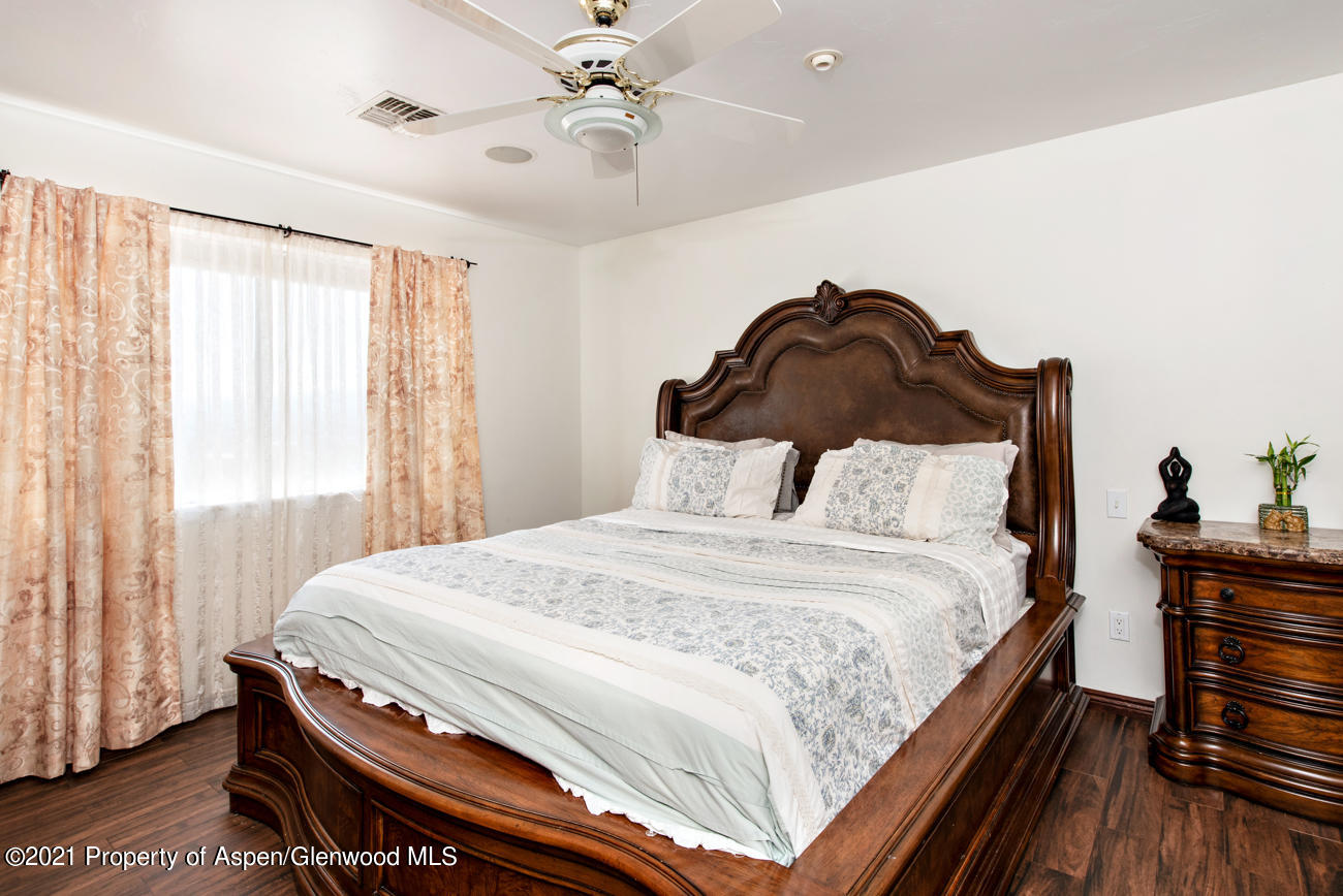 1090 Hickory Drive Rifle, CO 81650 - Photo 7 of 27 a bedroom with a bed and wooden floor