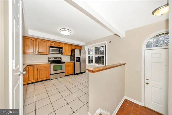 a kitchen with stainless steel appliances a refrigerator and a stove top oven