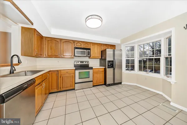 a view of a kitchen with microwave and cabinets