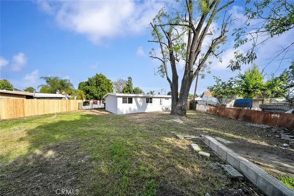 a view of a backyard with large trees