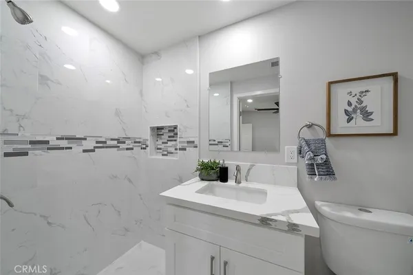 a bathroom with a sink a toilet and mirror