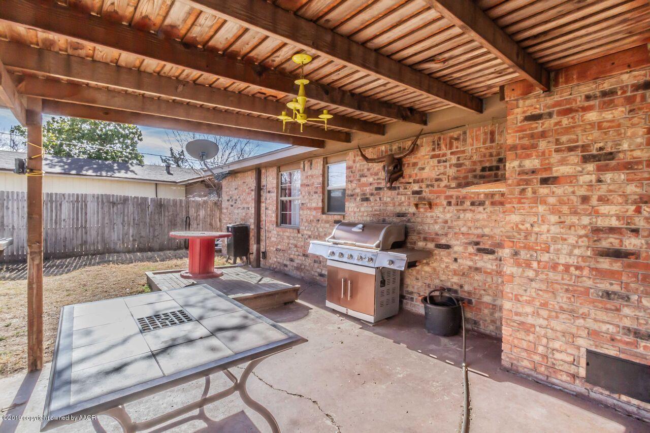 4709 Journey Street Amarillo, TX 79110 - Photo 38 of 43 a view of a patio with table and chairs a barbeque with wooden fence