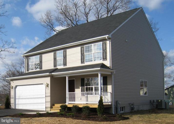 8012 Clark Station Road Severn, MD 21144 - Photo 1 of 8 a front view of a house with a garden