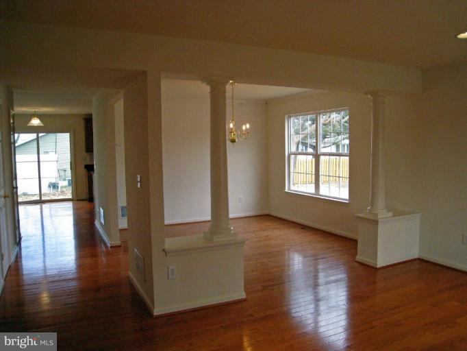 8012 Clark Station Road Severn, MD 21144 - Photo 3 of 8 a view of an empty room with wooden floor and a window