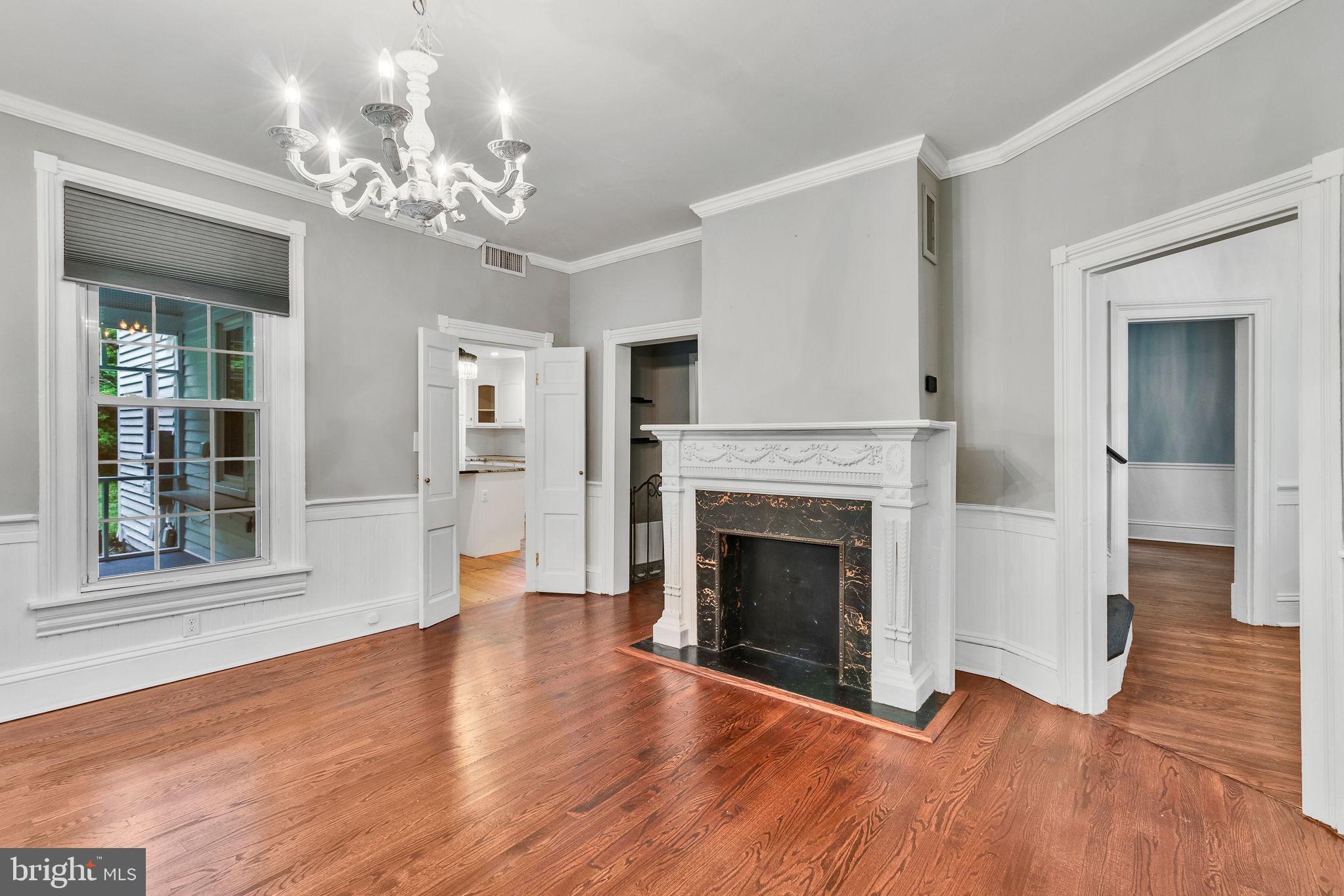 3952 Irvington Road Irvington, VA 22480 - Photo 7 of 77 a view of a livingroom with wooden floor and a fireplace