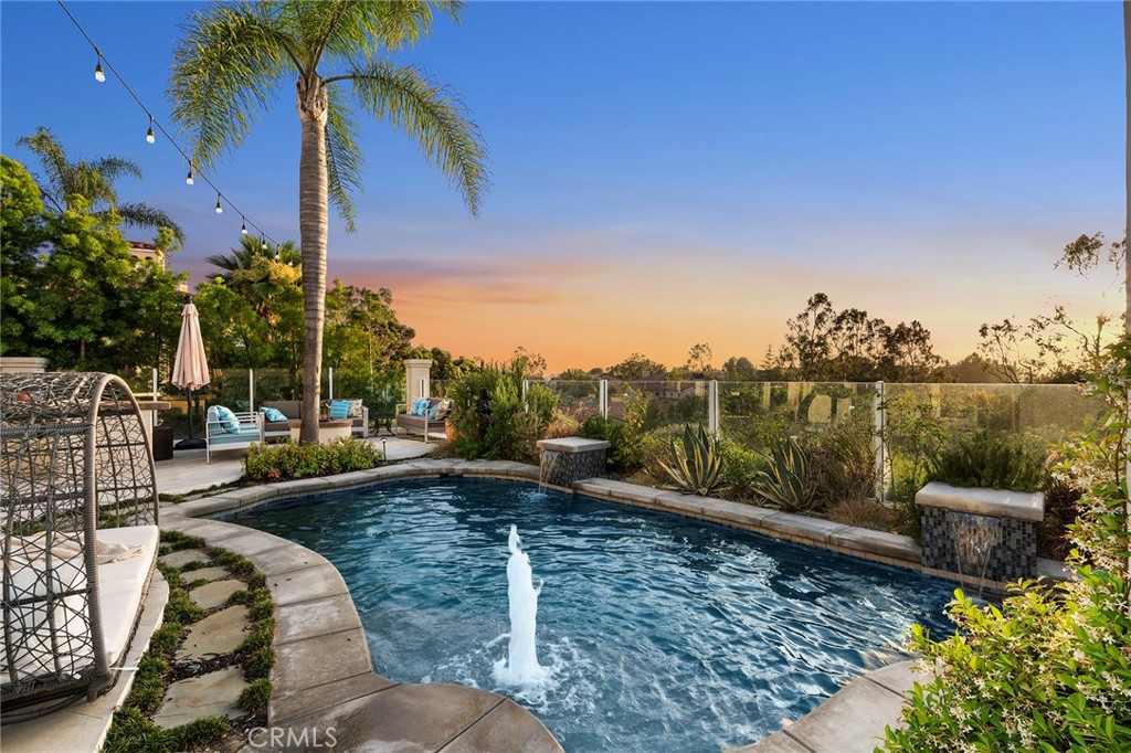 4 Peninsula Newport Coast, CA 92657 - Photo 2 of 20 a view of a swimming pool with a patio and a garden