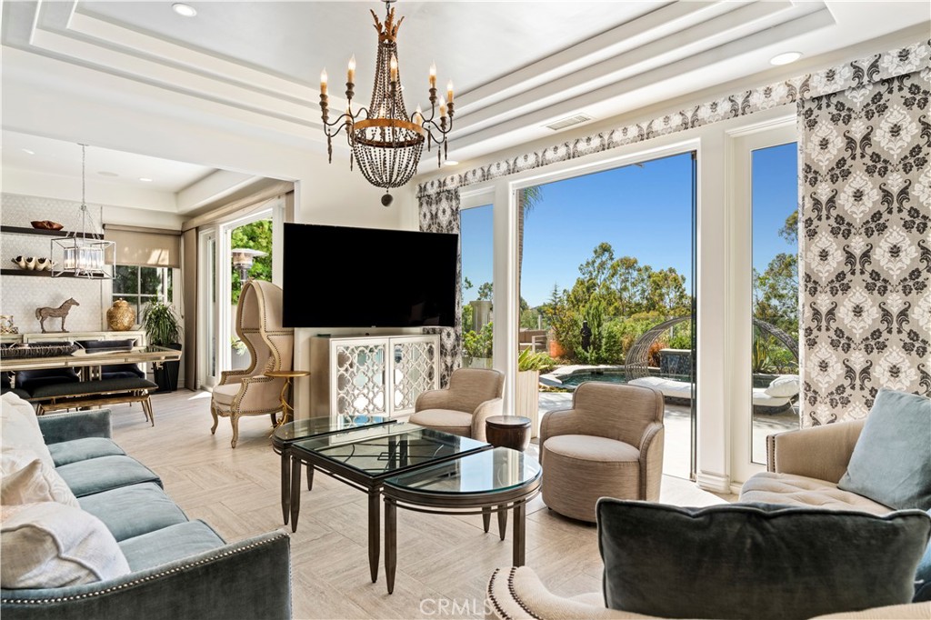 4 Peninsula Newport Coast, CA 92657 - Photo 5 of 20 a living room with furniture a flat screen tv and a chandelier