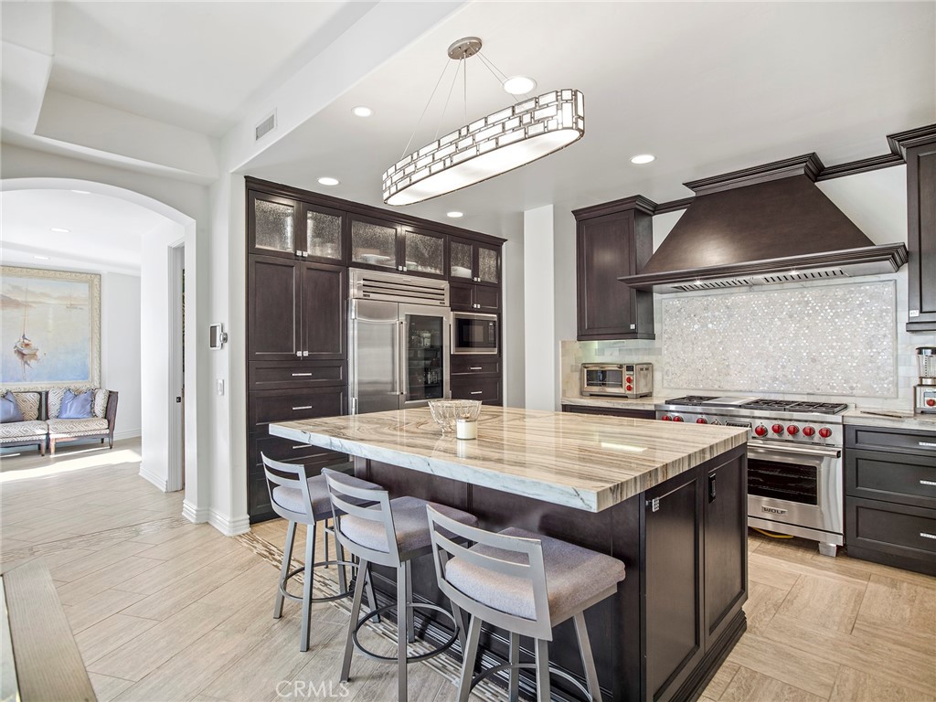 4 Peninsula Newport Coast, CA 92657 - Photo 8 of 20 a kitchen with a stove a table and chairs