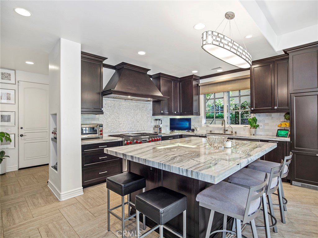4 Peninsula Newport Coast, CA 92657 - Photo 9 of 20 a kitchen with a stove a refrigerator and a dining table