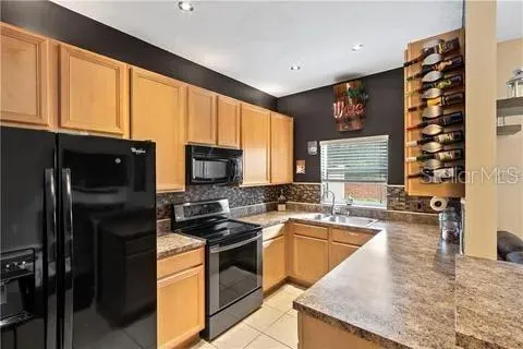 a kitchen with a sink stove and refrigerator