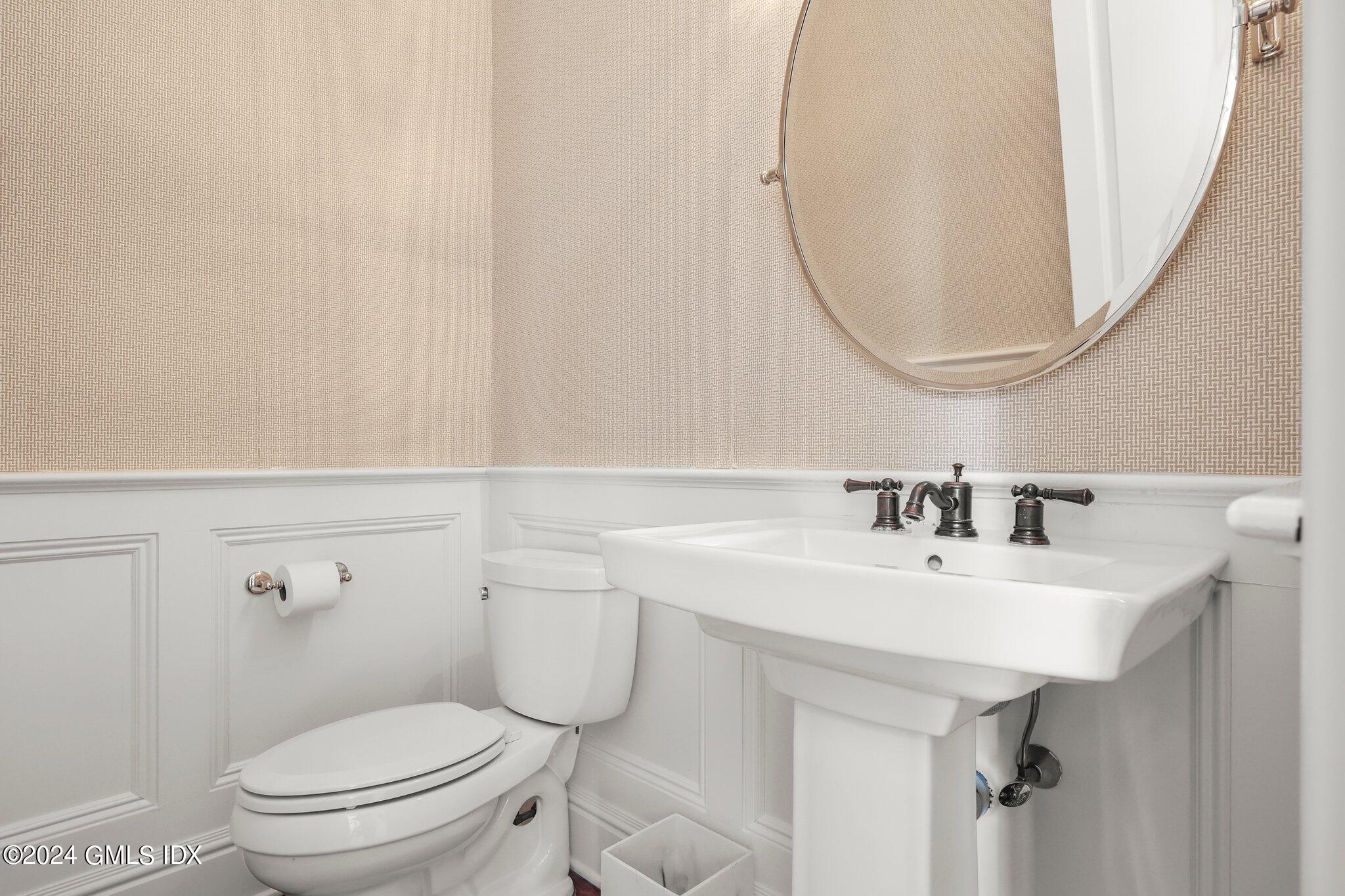 6 Coachlamp Lane Greenwich, CT 06830 - Photo 14 of 33 a bathroom with a sink a toilet and a mirror