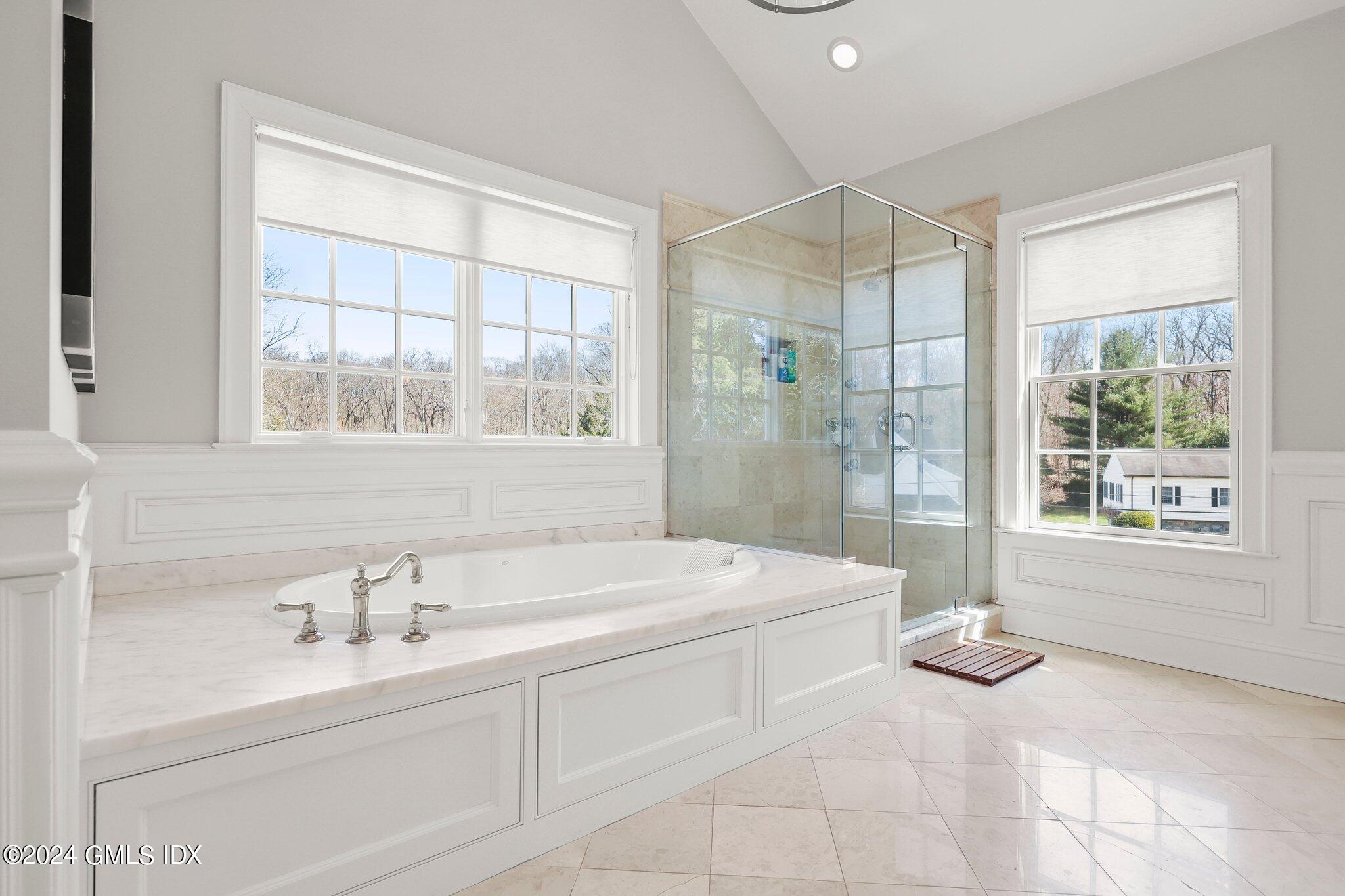 6 Coachlamp Lane Greenwich, CT 06830 - Photo 19 of 33 a bathroom with a tub sink and mirror