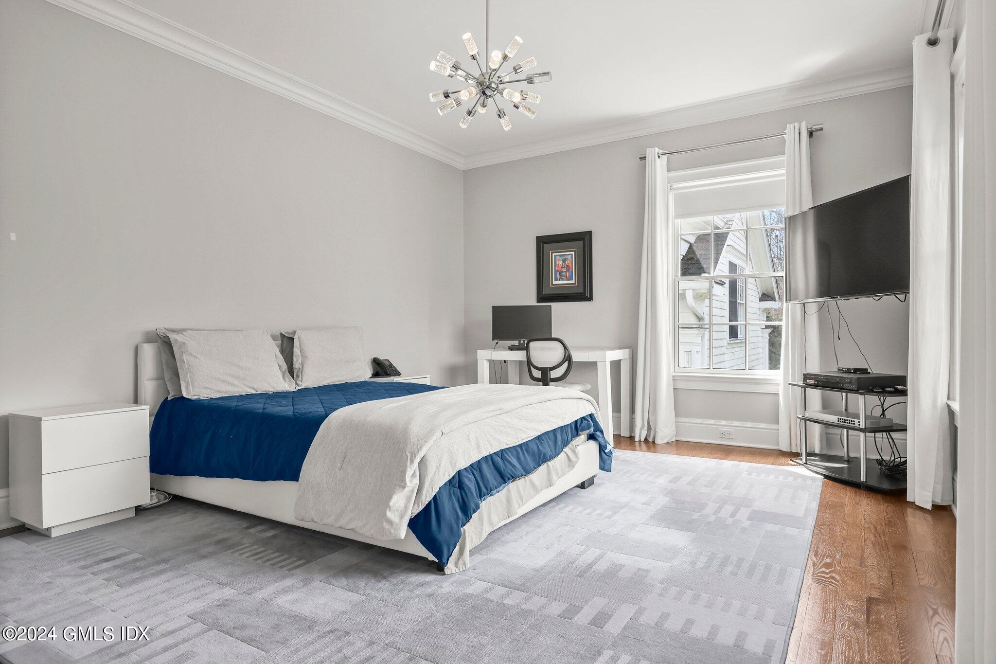 6 Coachlamp Lane Greenwich, CT 06830 - Photo 21 of 33 a spacious bedroom with a bed and a flat screen tv