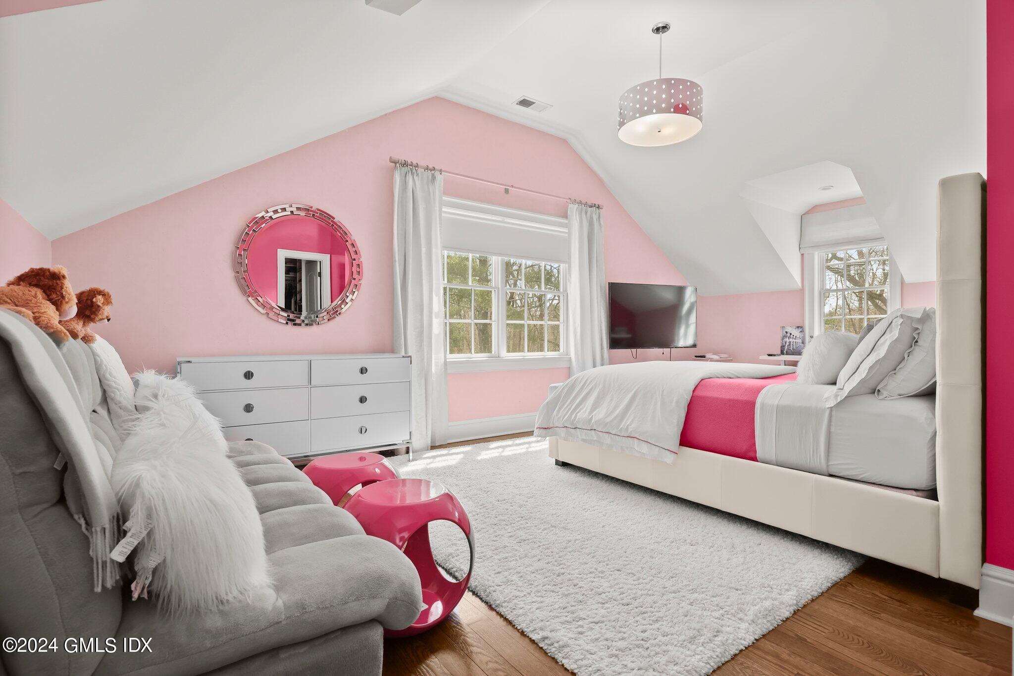 6 Coachlamp Lane Greenwich, CT 06830 - Photo 22 of 33 a bedroom with a bed and wooden floor