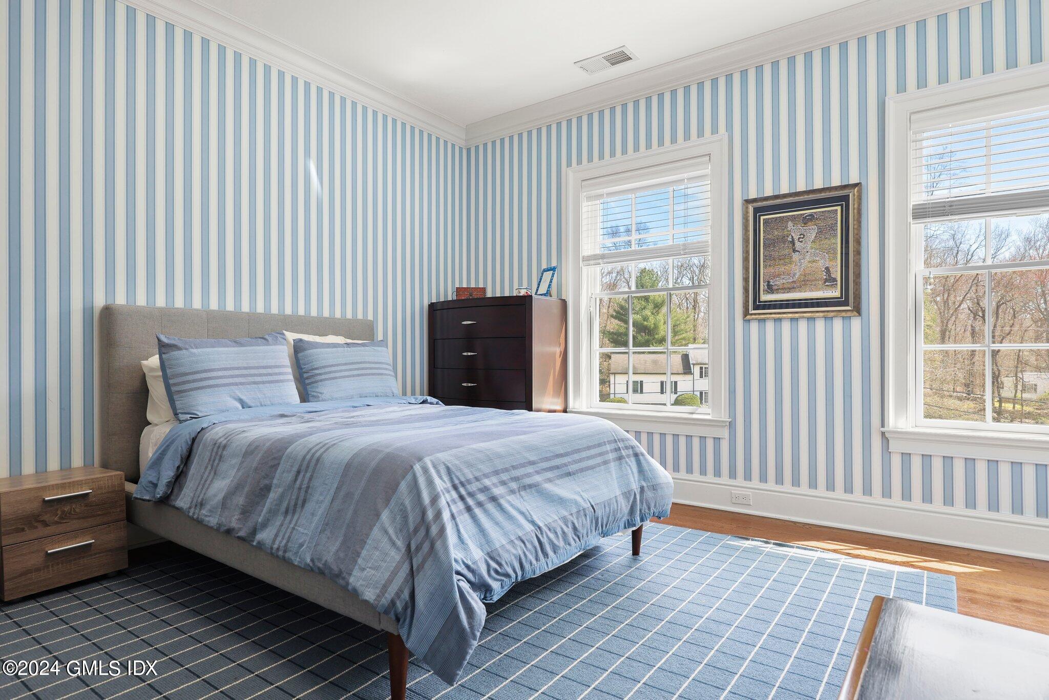 6 Coachlamp Lane Greenwich, CT 06830 - Photo 25 of 33 a bedroom with a bed and a window