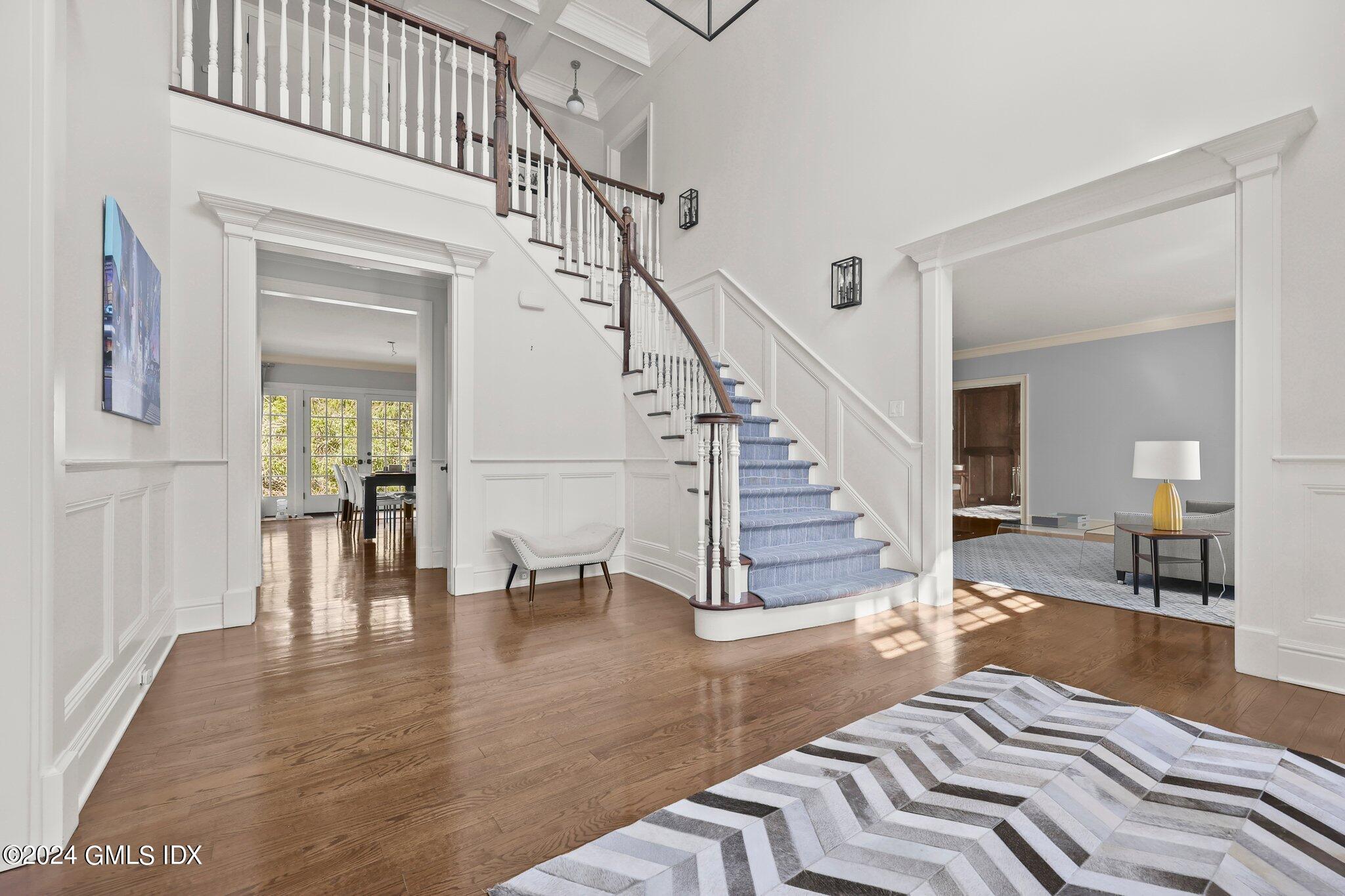 6 Coachlamp Lane Greenwich, CT 06830 - Photo 3 of 33 a view of a livingroom with wooden floor and a floor to ceiling window