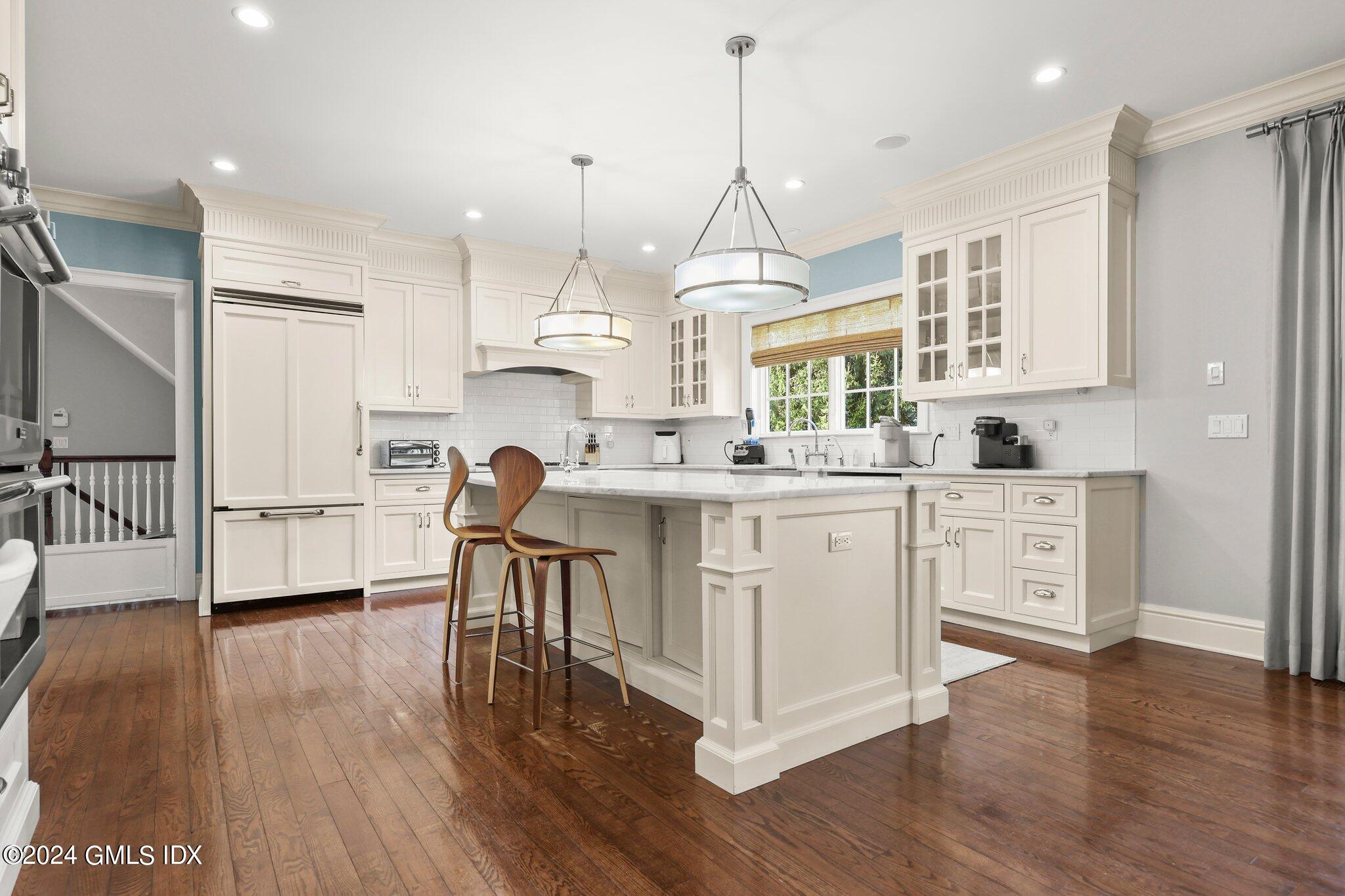 6 Coachlamp Lane Greenwich, CT 06830 - Photo 8 of 33 a kitchen with white cabinets and window