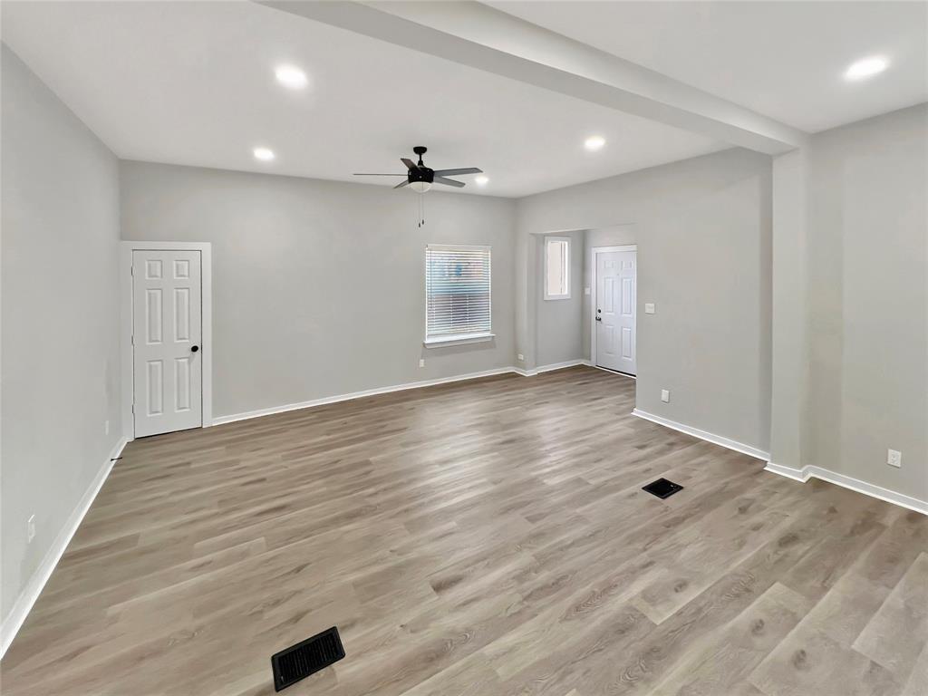 5530 Reiger Avenue, Unit 5528 Dallas, TX 75214 - Photo 11 of 40 an empty room with wooden floor and windows