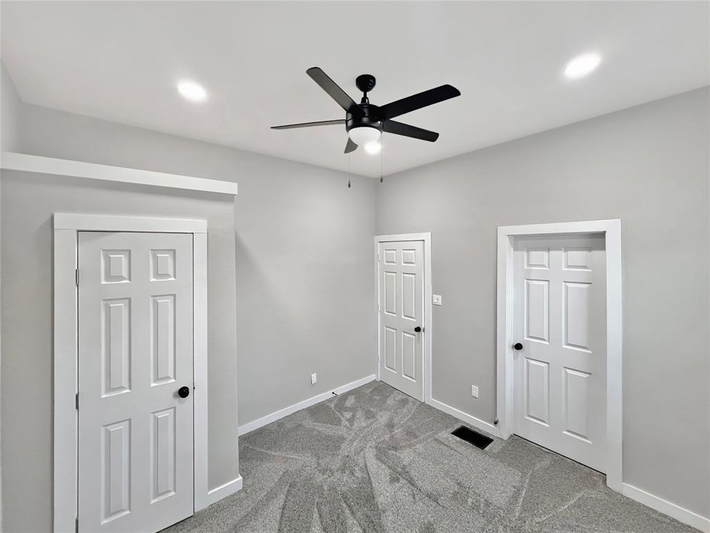 5530 Reiger Avenue, Unit 5528 Dallas, TX 75214 - Photo 17 of 40 a view of a livingroom with a ceiling fan & windows