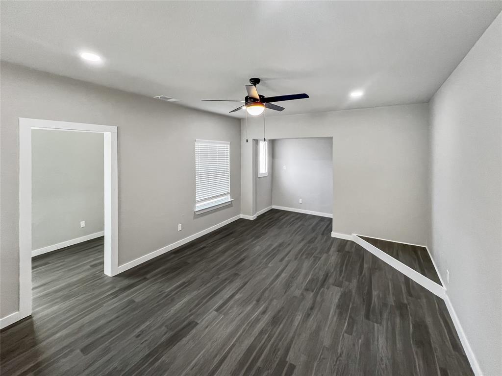 5530 Reiger Avenue, Unit 5528 Dallas, TX 75214 - Photo 21 of 40 a view of an empty room with wooden floor and a ceiling fan